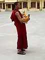 Gyuto monk carrying statues