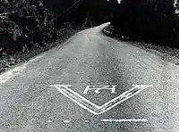 Resistance graffiti on a Norwegian road, depicting the V-sign together with the H7 monogram