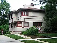 A two-story house surrounded by trees