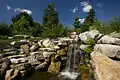 A waterfall empties into a pond at the garden.