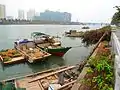 A view from the south side, about midpoint of the length of the river, facing east, with Haidian Island on the opposite bank, with Heping Bridge visible in background.