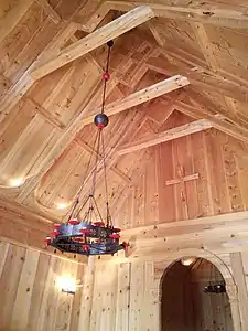 Roof beams shown from the inside of a small wooden church.