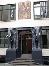 A portal with the front of two elephants beside the door.