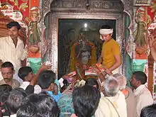 Hanuman Garhi temple. A young priest is operating the Darshan system.