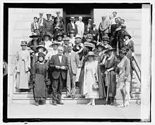 A 1920 photo of women and men of the National Women's party trying to convince Senator Harding to provide them with the 36th state.