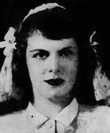 A young white woman in a bridal portrait, wearing a veil and collared blouse