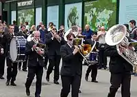 A marching band with a variety of horns and drums.