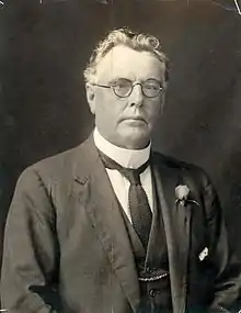 a black and white portrait of a man in formal dress