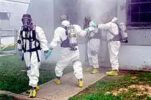 DEA agents wearing Level B hazmat suits.