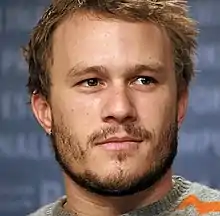 A headshot of Heath Ledger as he looks away from the camera