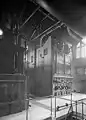 A black-and-white photo a Boiler No. 3 in the pumping station. It is a tall, rectangular machine with lots of buttons on it