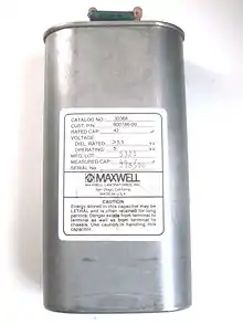 This high-energy capacitor from a defibrillator has a resistor connected between the terminals for safety, to dissipate stored energy.