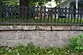 Iron fence and stone retaining wall