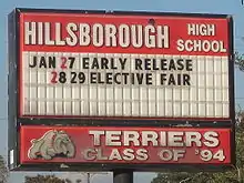 Hillsborough High School letter board of upcoming events, with "Terriers Class of '94" and dog mascot logo.