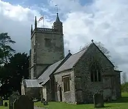 Stone building with square tower.