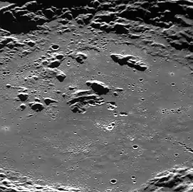 Oblique view of the central crater.  Some of the irregular, bright depressions are hollows.