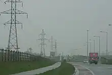 A road with transmission towers on both sides in Hollystown in West Dublin.