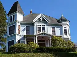 Photograph of a large house on top of a steep hill