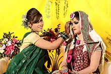 Image 15Relatives decorating the bride with traditional wedding turmeric in a Bangladeshi Gaye Holud ceremony in Dhaka. (from Culture of Bangladesh)