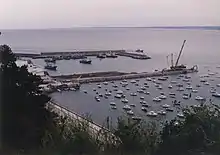 Two fishing craft within two quays and several pleasure crafts outside.