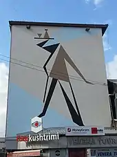 Modern outdoor mural of a waiter with a tray