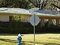 A house in Hunters Creek Village along with another style street sign