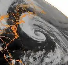 A satellite image of a loosely organized hurricane offshore of the Eastern United States