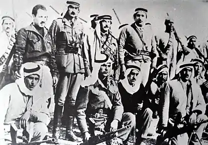 Abd al-Qadir al-Husayni returned to Palestine after an exile of ten years, and began organizing Arab resistance to forcible partition of the country. He is seen here (standing center) with aides and Palestinian irregulars, Jerusalem district, February 1948