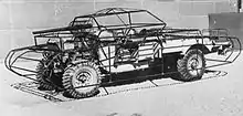 photograph of a wheeled chassis fitted with the frame of a dummy tank