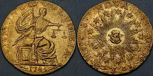 Both sides of a gold coin, depicting a seated figure and an allegorical all-seeing eye