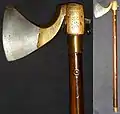 Indian (Southern) tabar (axe), 18th century, the wooden haft has a steel tang running 3/4 of the way down, pinned by four rivets. The axe head is brass with a forged steel blade, L. 58 cm.