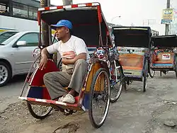 Becak and driver, Ciputat, South Tangerang, Indonesia.