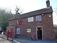 The brick tollhouse at the south end of the bridge