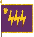 The traditional colour of the Eastern Finland Signals Battalion, part of the Karelia Brigade, has the branch colours of signals corps: purple and gold. The device featuring a western capercaillie is a throwback to the earlier designation as Central Finland Signals Battalion. The main device, the three lightning bolts, is symbolic of communication.