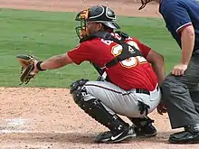 A baseball player in red and gray