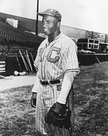 A black man in baseball uniform with the letters "K" and "C" on the chest