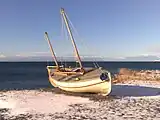 The replica of James Caird at the Museo Nao Victoria in winter with snow.