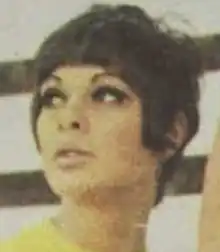 A young brown-skinned woman with short dark hair, wearing a yellow top