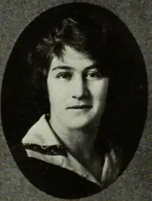 A young white woman with dark hair, in an oval frame