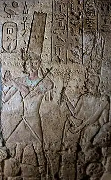 Taharqa, followed by the sistrum shaking queen Takahatenamun in the Jebel Barkal Temple of Mut.