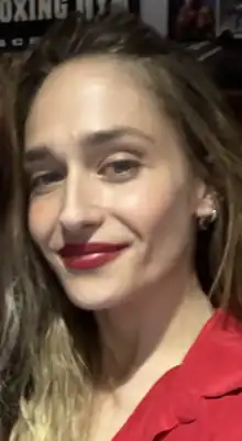 A selfie of Jemima Kirke in a red outfit.