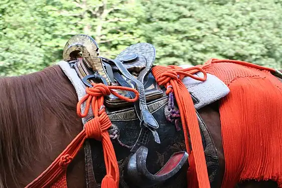 Abumi in use with a Japanese saddle (kura).