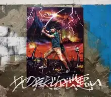 The single's cover, illustrated by Nanpei Kaneko. It features a poster of Hoshino (in-costume as his character from the Why Don't You Play in Hell? film) and a girl, holding swords in a wasteland, on top of a graffitied wall. Below the poster is the Japanese title written with a spray can.