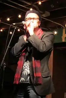 Joe Filisko playing a harmonica live in 2013