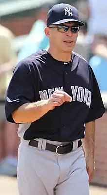 A man in a navy blue baseball uniform with the word "New York" written across the front