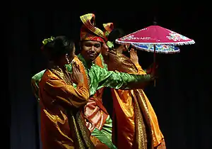 Dancers in traditional Malay costume during a dance