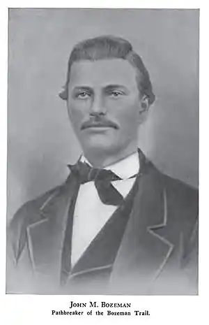 B&W image of a man with oiled hair and a wide moustache