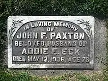 Flat stone marker engraved with Paxton's name