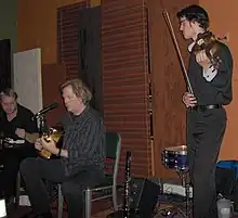 John Jorgenson Quintet at Kentucky Coffee Tree Cafe in Frankfort, Kentucky; left to right: Kevin Nolan, rhythm guitar; John Jorgenson, guitar; Jason Anick,  violin