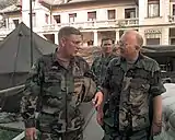 Colonel Jeffrey Hage of the United States National Intelligence Center (USNIC) in Bosnia escorts Abrams through the center during Operation Joint Endeavor in 1996